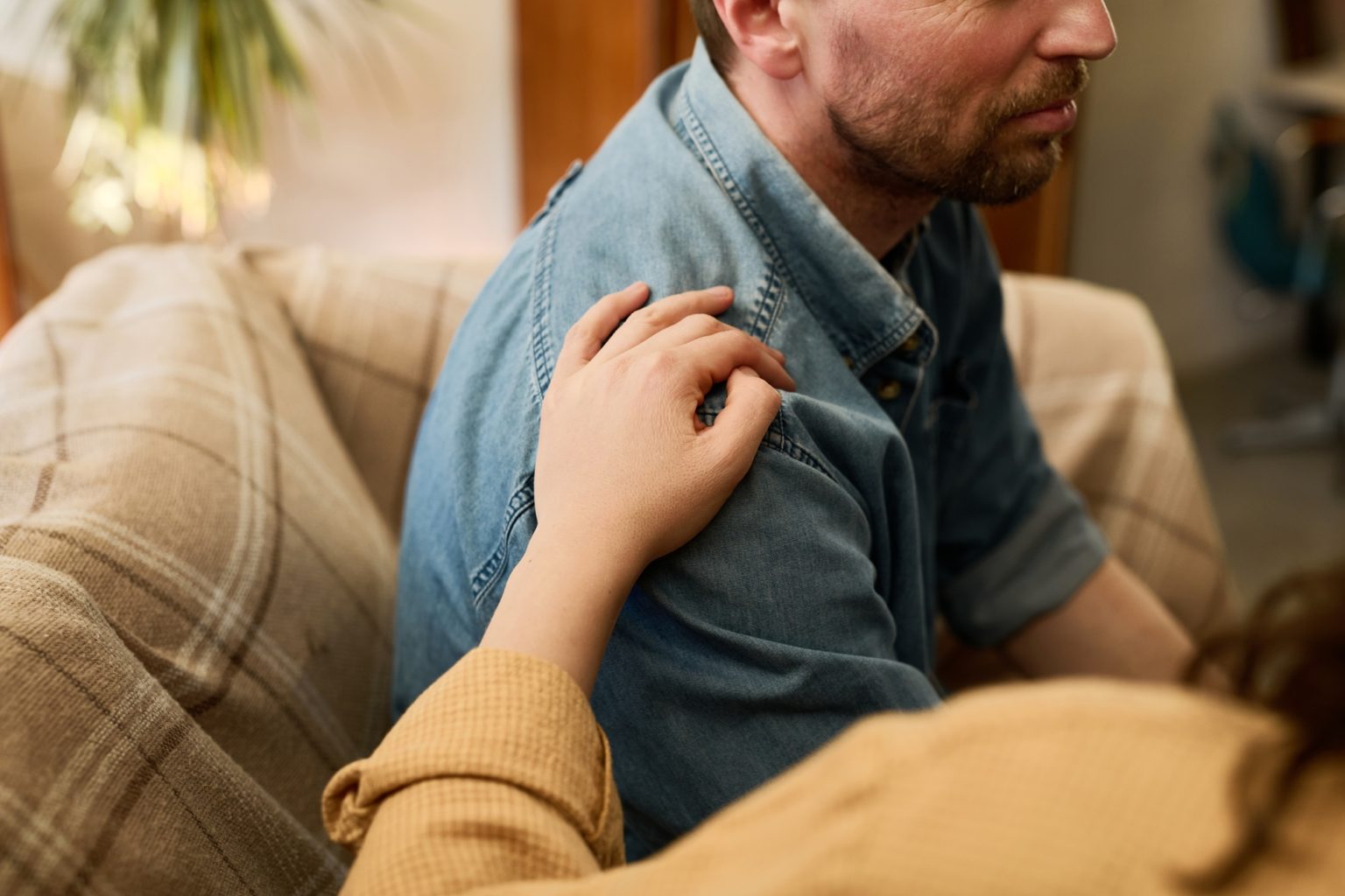Man in depression supporting by woman