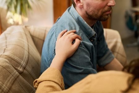 Man in depression supporting by woman