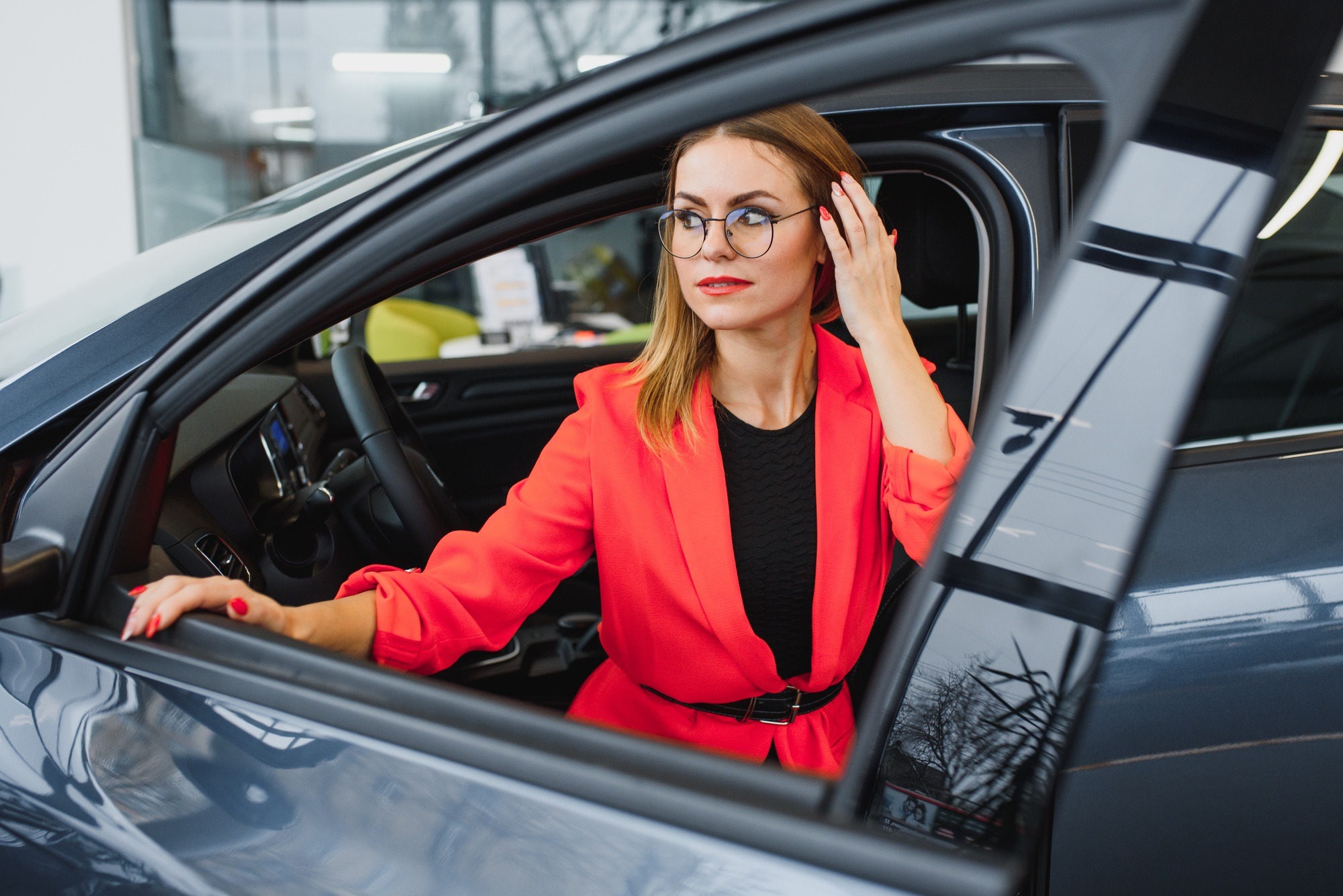 business woman buys a car at a car dealership