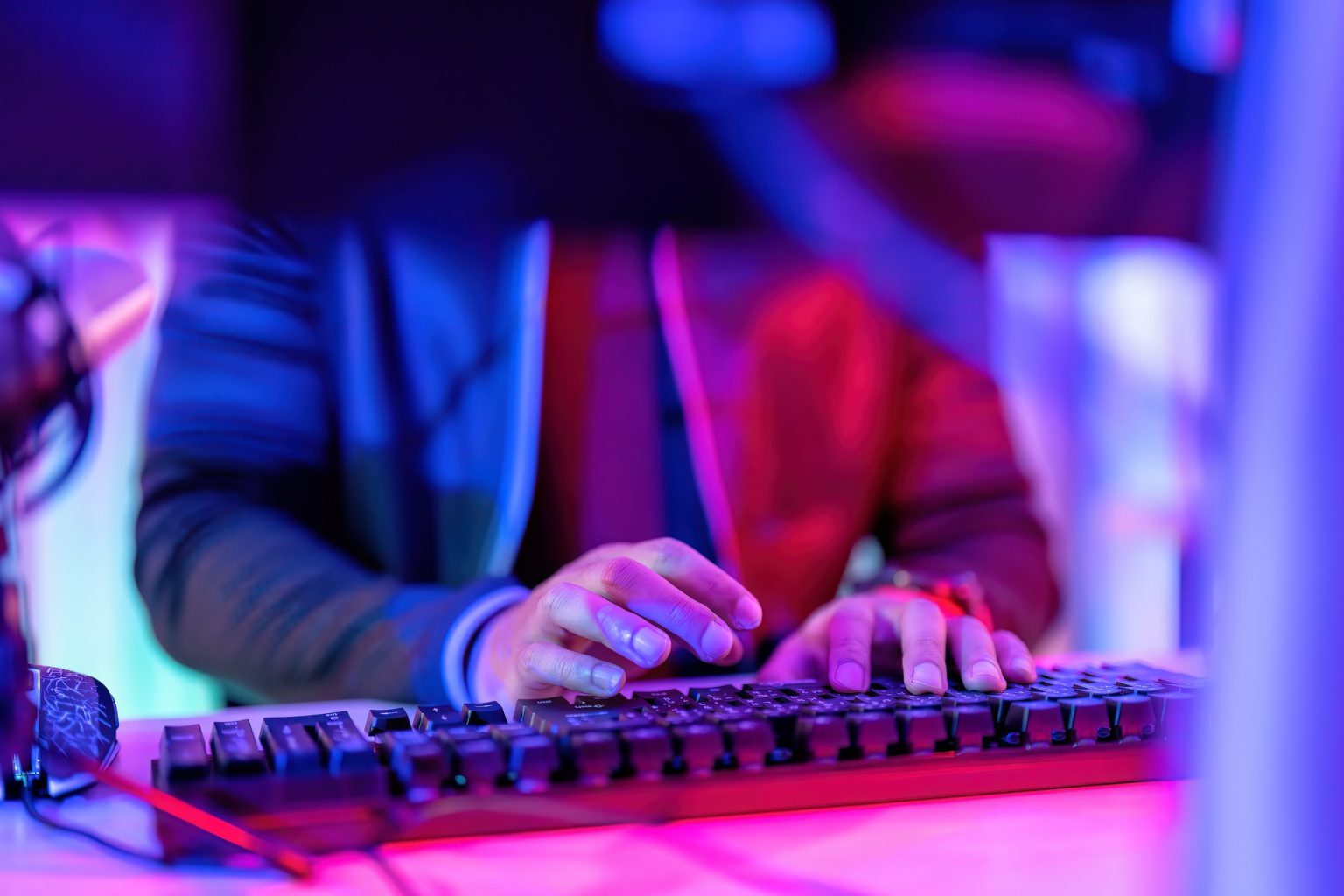 hacker wearing hood jacket typing computer keyboard to phishing steal attack