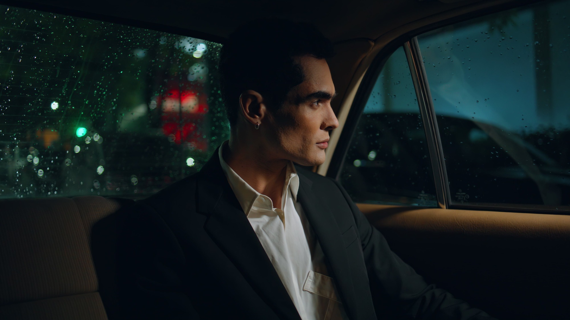 Handsome businessman looking car window at night closeup. Man travelling auto