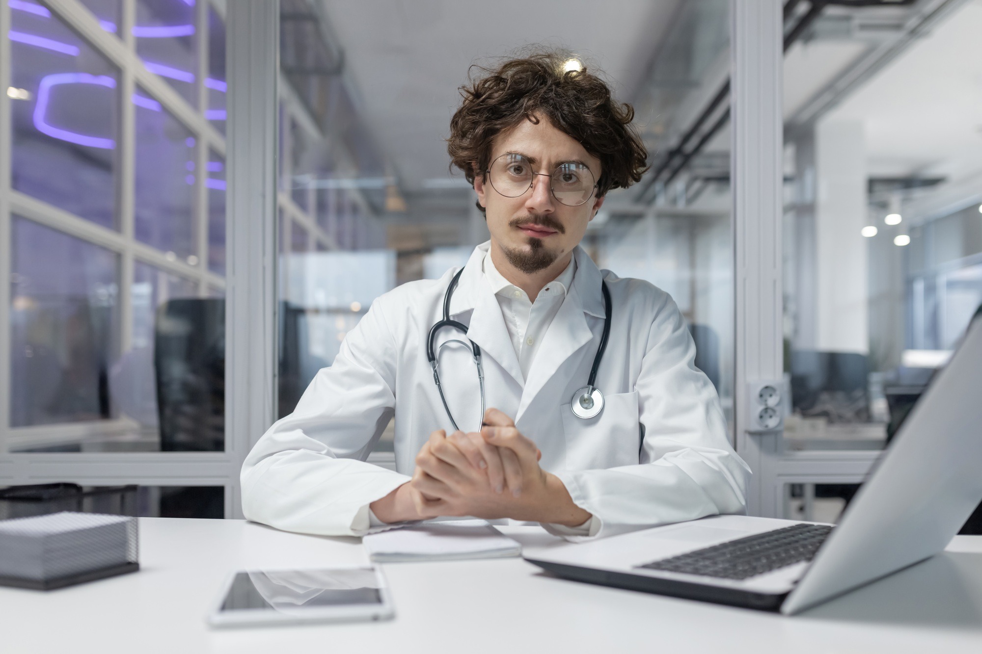 Male Doctor at Desk With Laptop, Medical Professional in Clinic Office