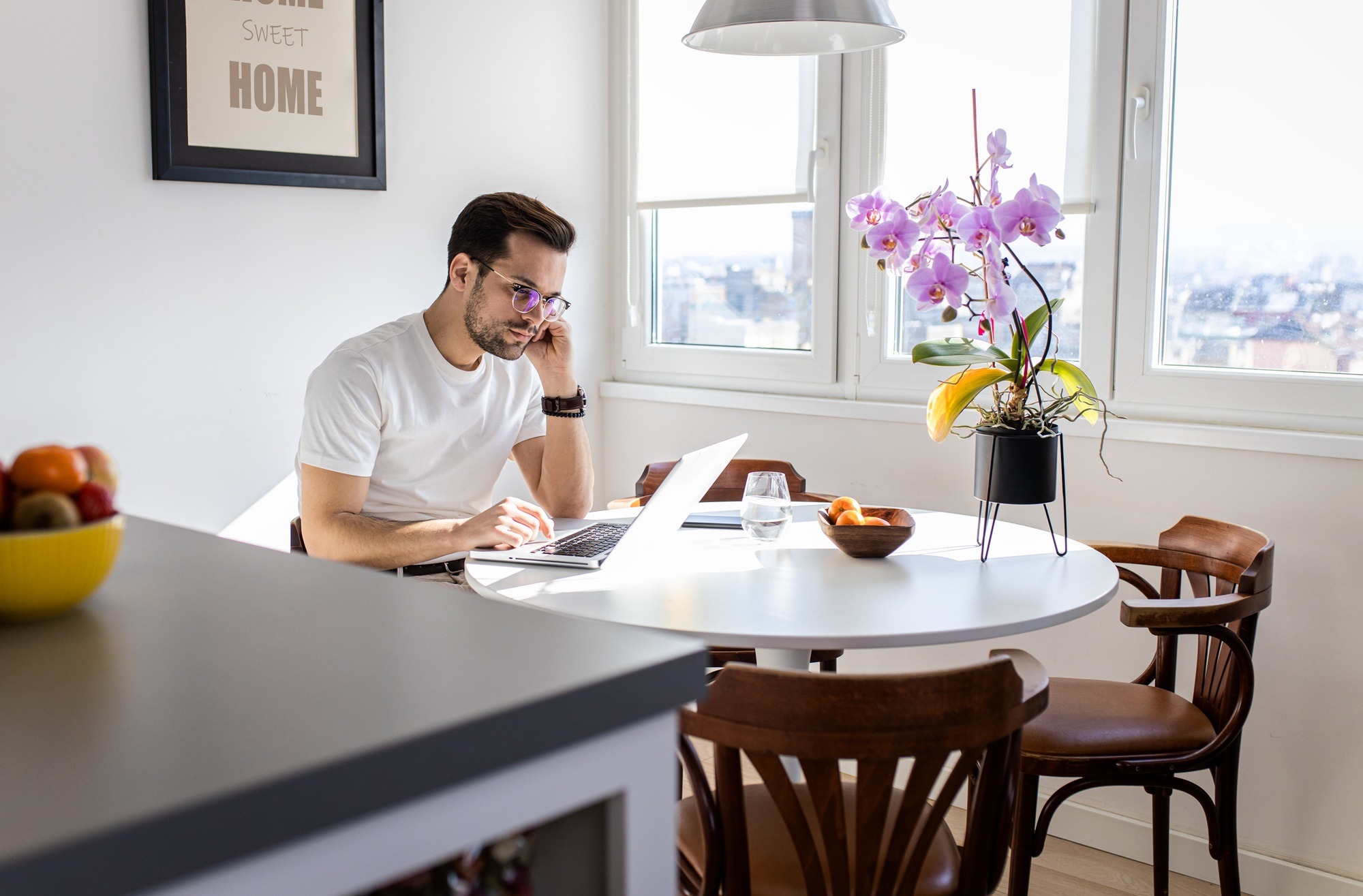 Man working at home using laptop.
