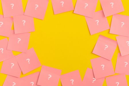 Sticky notes on yellow background. Question mark.