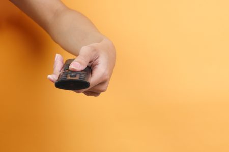 Hand Holds TV Remote