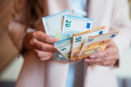 a girl holds banknotes money euro in her hands for payment