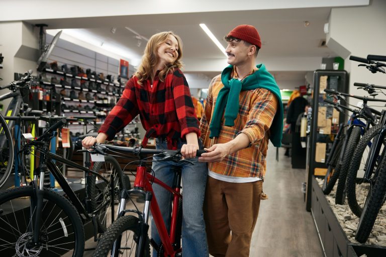 Boyfriend buying bicycle for loving girlfriend at sport bike shop