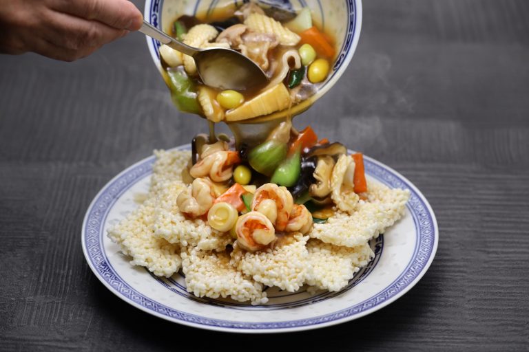 Chinese crispy or sizzling rice with thickened sauce, seafood, and vegetables.
