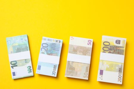 Euro money on yellow background, top view