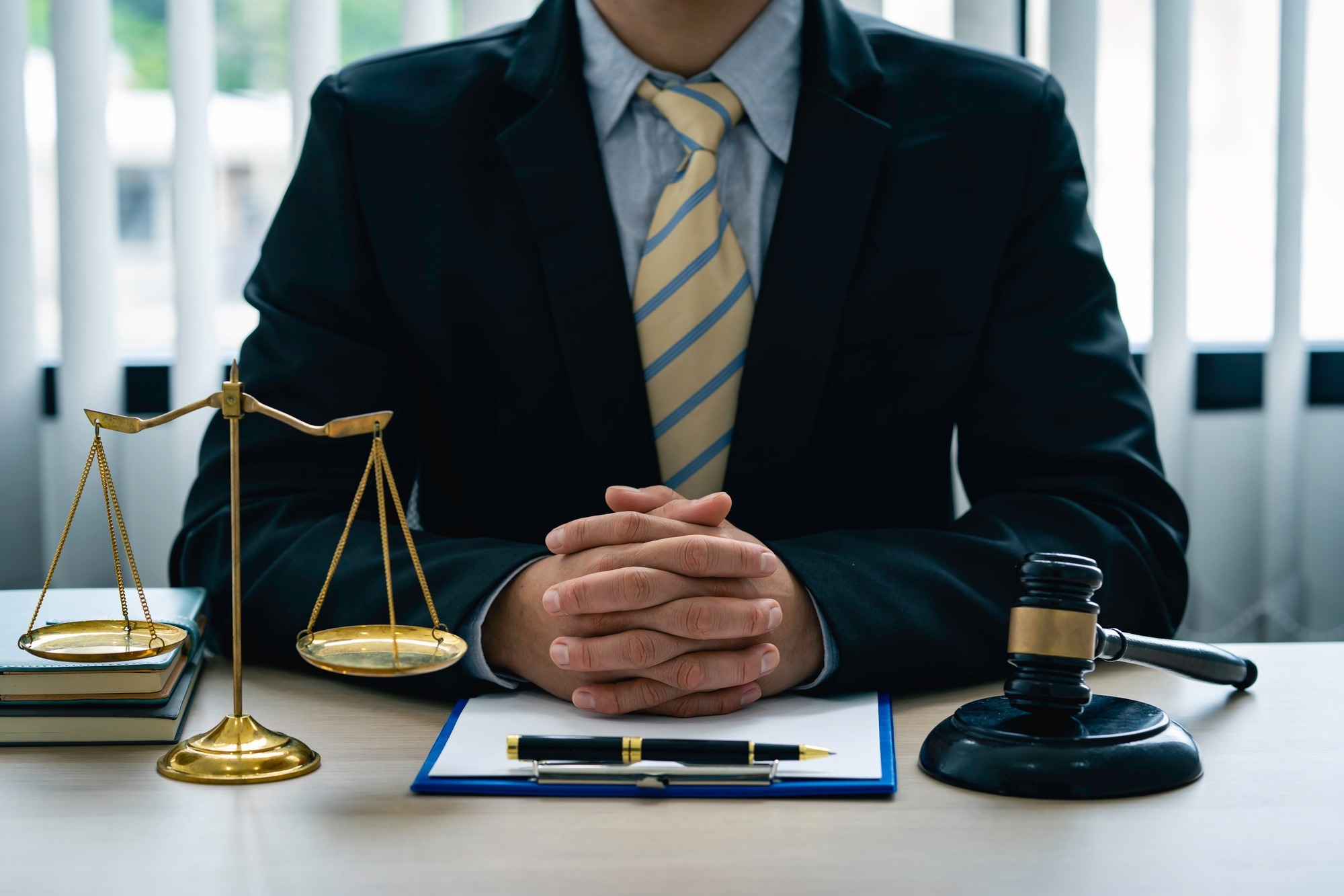 A lawyer or judge is listening to a legal testimony from a client in the lawyer's office. legal advi
