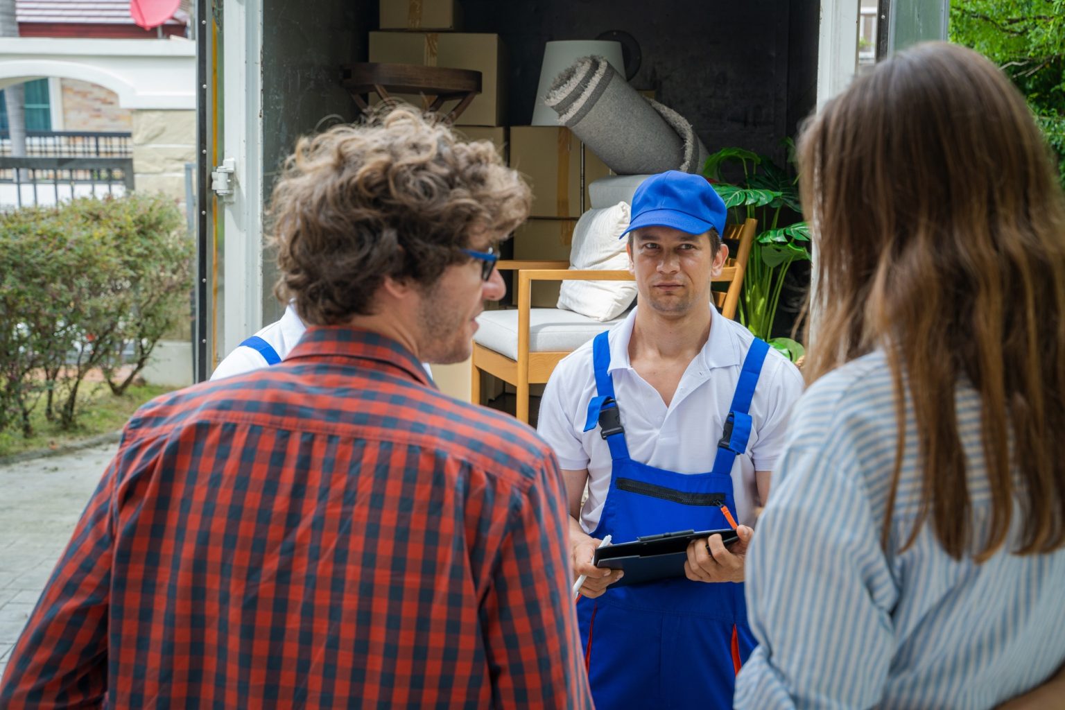 House moving service,Homeowner checking delivery list cardboard.