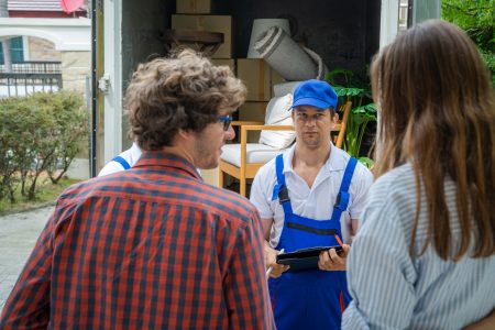 House moving service,Homeowner checking delivery list cardboard.