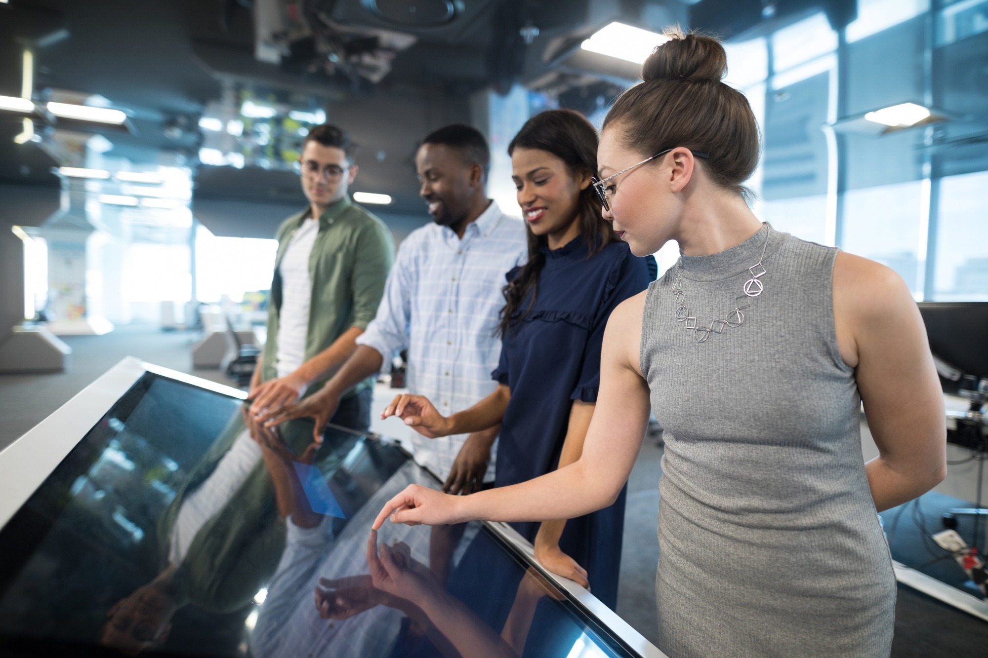 Business executives touching digital screen