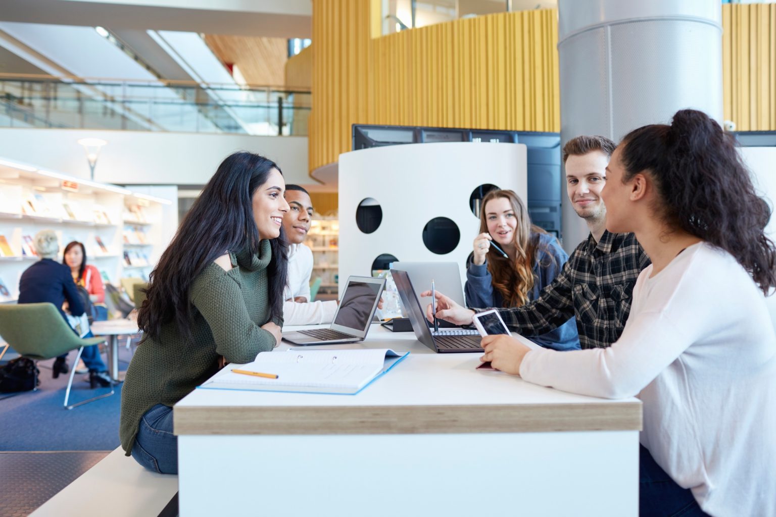 University students using laptops and digital tablet, working together
