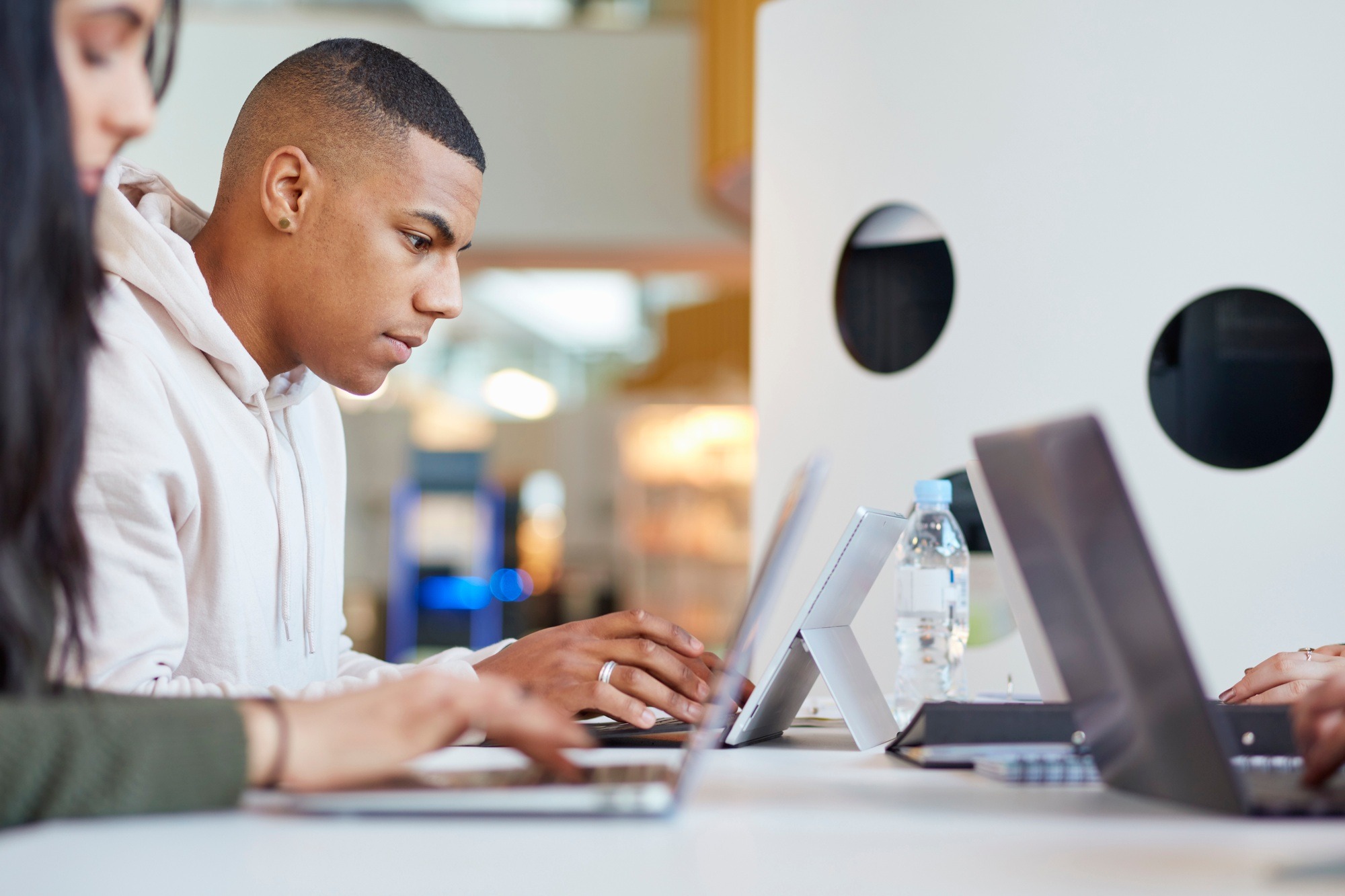 University students using laptops and digital tablet, working together
