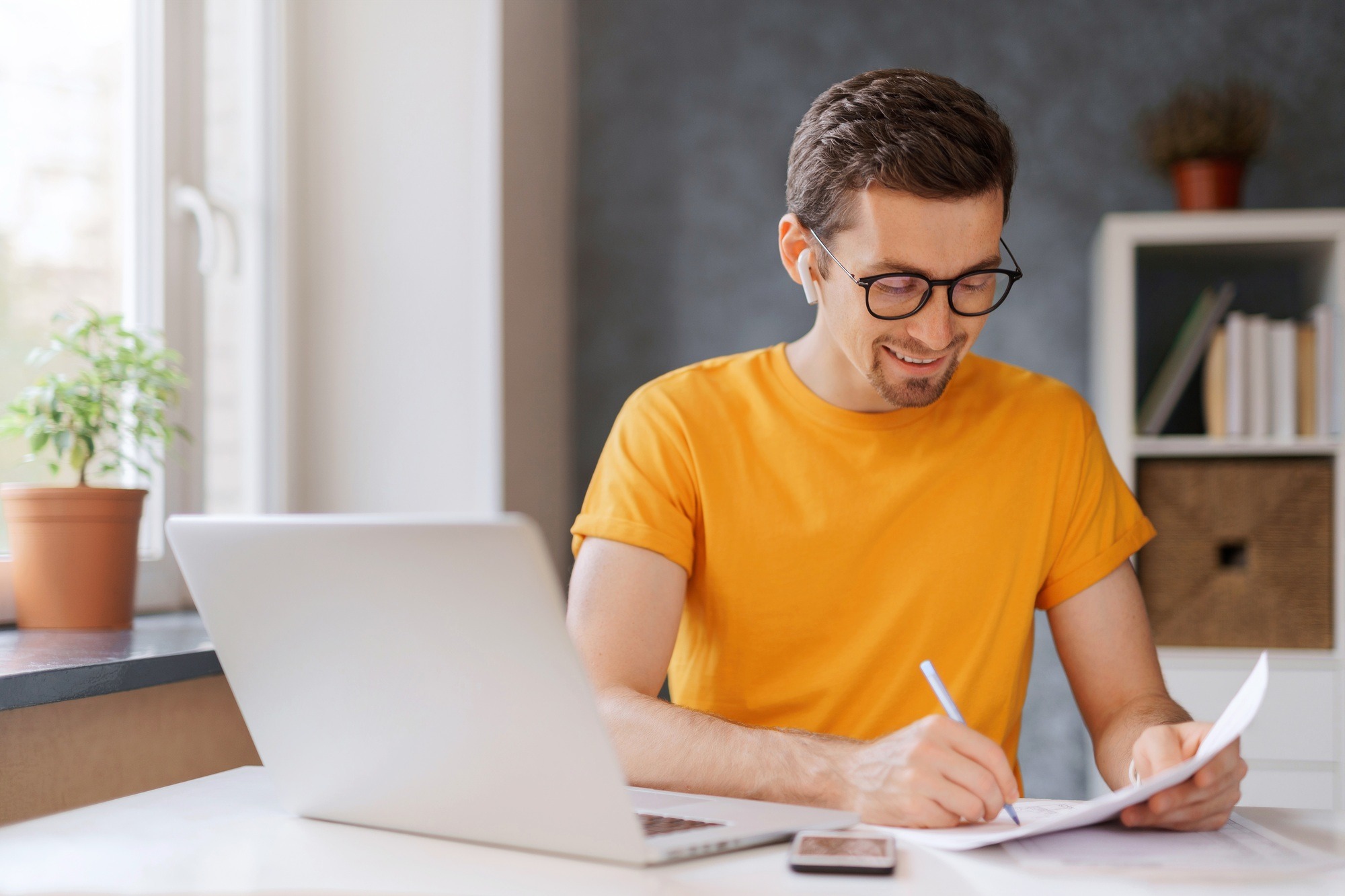 Young student using laptop for e-learning at home