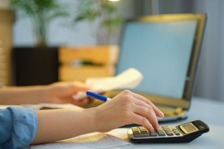 bank account book while holding the bills to calculate in living room at home