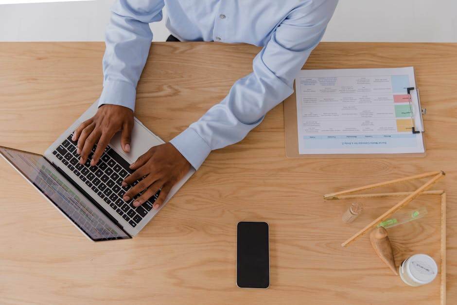 Person using a laptop to complete an online government address change form