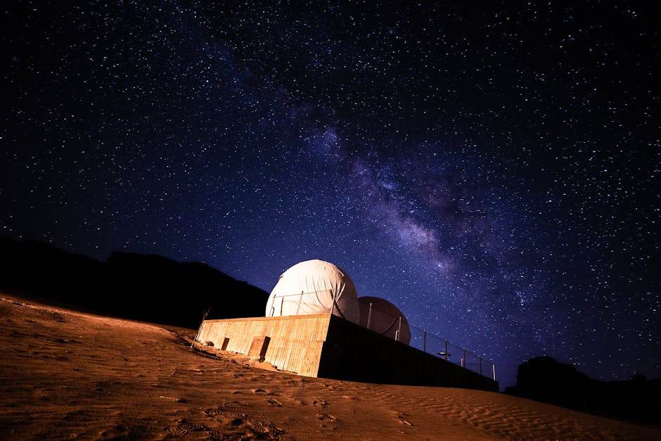 Astronomer observing the night sky with telescope