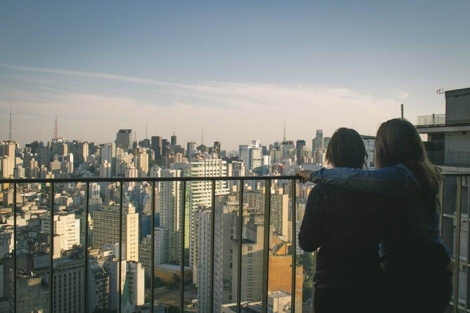 Young couple looking at apartment balcony and city view during lockdown