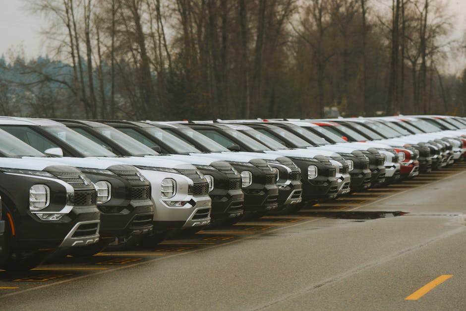 New cars lined up at a dealership with financing and leasing concept
