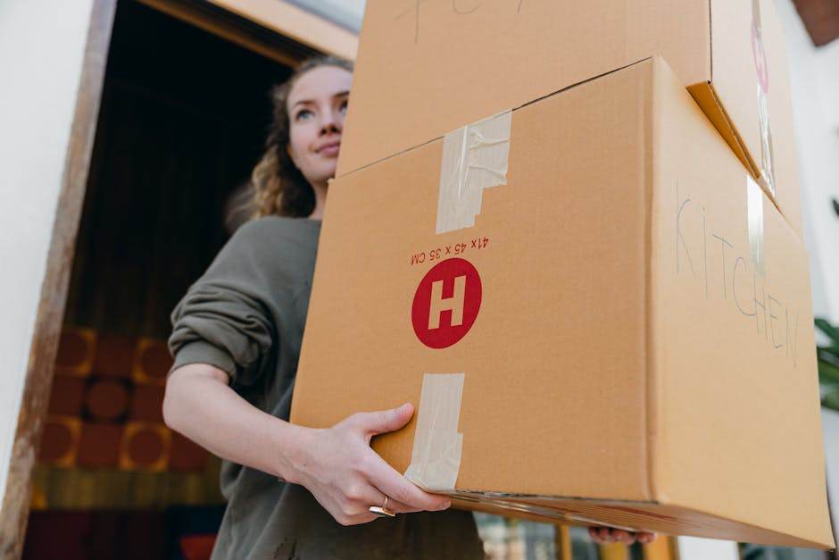 Moving truck and packed boxes outside a home