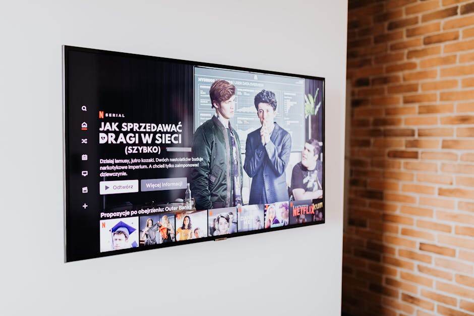 Person watching Netflix on a 4K smart TV in a modern living room