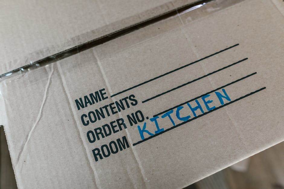 Person packing moving boxes in a bright apartment