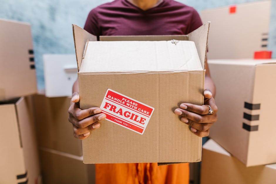 Person moving boxes in a new apartment during a home relocation