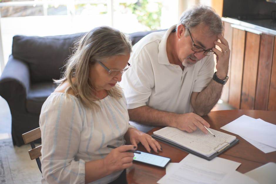 Senior couple reviewing healthcare costs at home