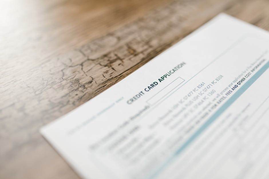 Rachat de crédit : les garanties qui font ou défont votre dossier A credit card application on a wooden desk, depicting finance and banking tasks.