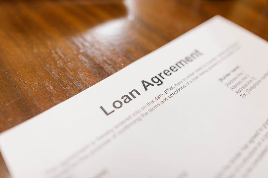 Person signing a loan agreement with a bank advisor