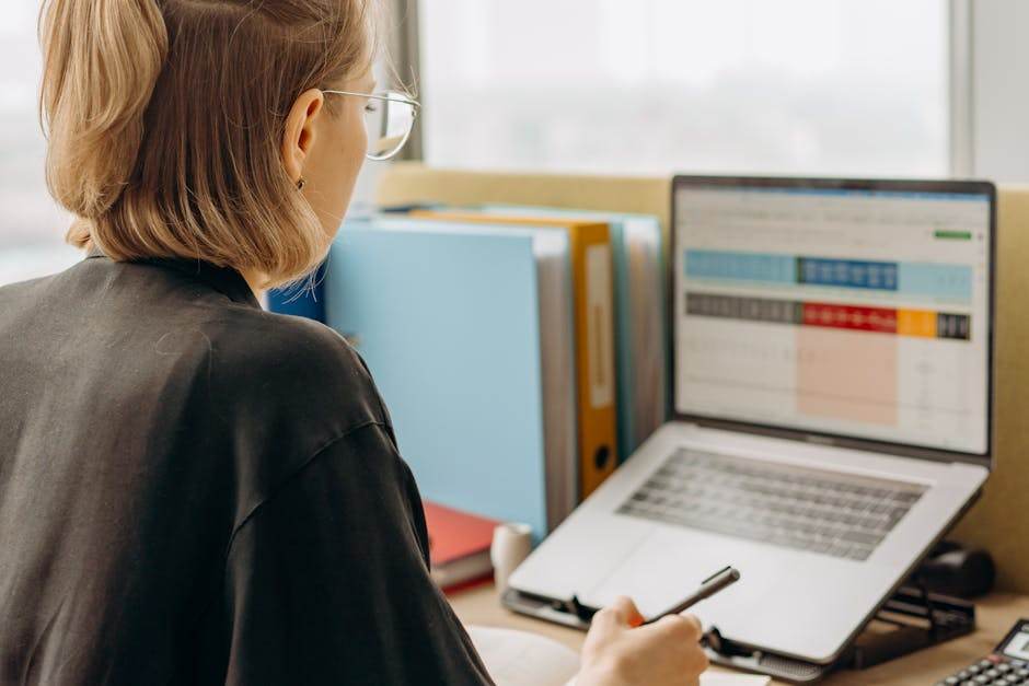 Person using a laptop to manage an online administrative change