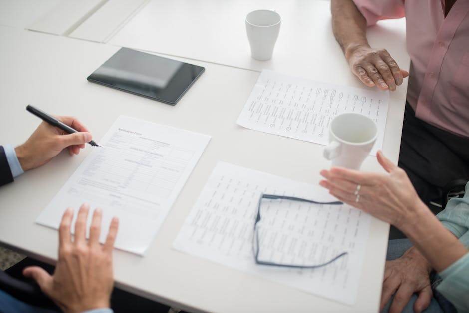 People reviewing insurance coverage and benefits at a table