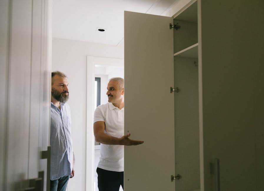 Person inspecting an empty apartment room with natural light and a checklist