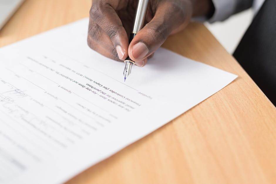 Person signing documents remotely on a laptop at home