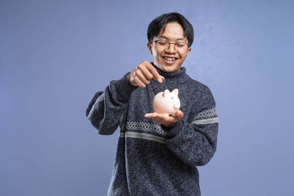 Young adult using mobile banking app to manage savings