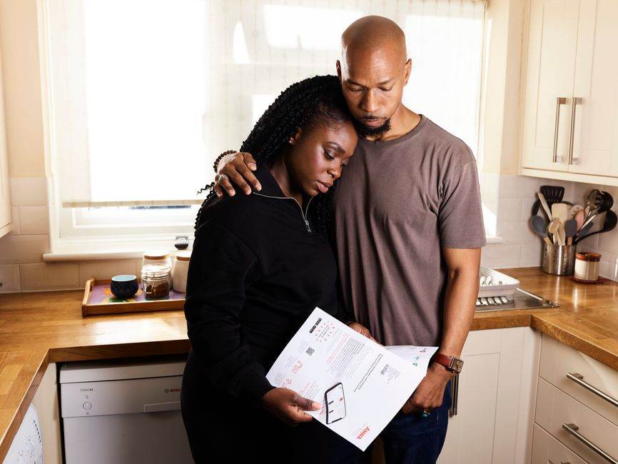 Family discussing energy bills at kitchen table