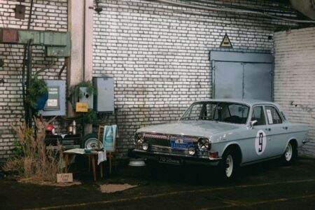 Retro Gaz car parked in urban Minsk garage setting with industrial vibes.