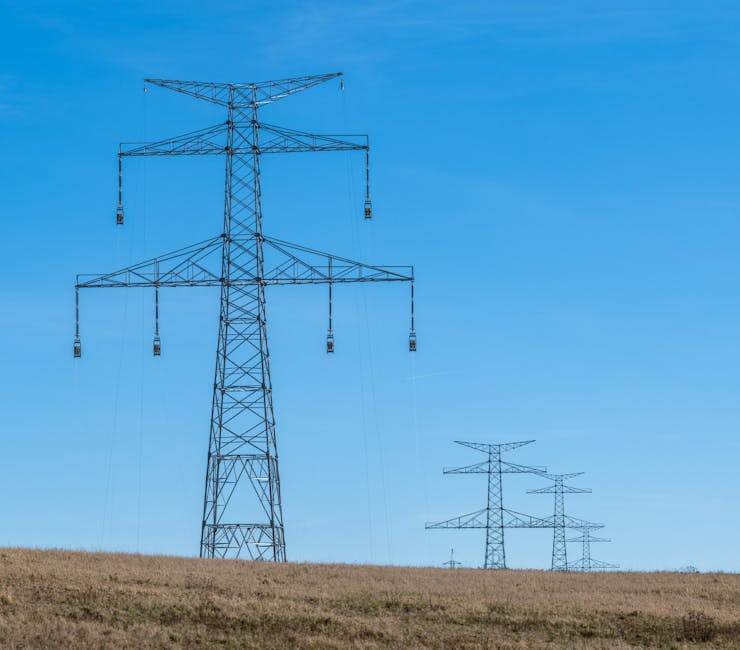 High-voltage power lines crossing a border landscape