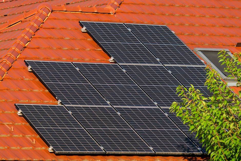 Residential rooftop solar panels on a house in daylight