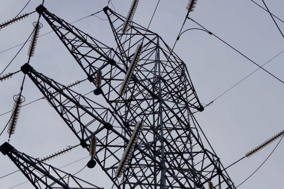 Power lines and electricity network infrastructure at sunset