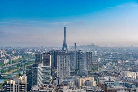 Stunning aerial view of Paris cityscape featuring the Eiffel Tower and urban landscape.