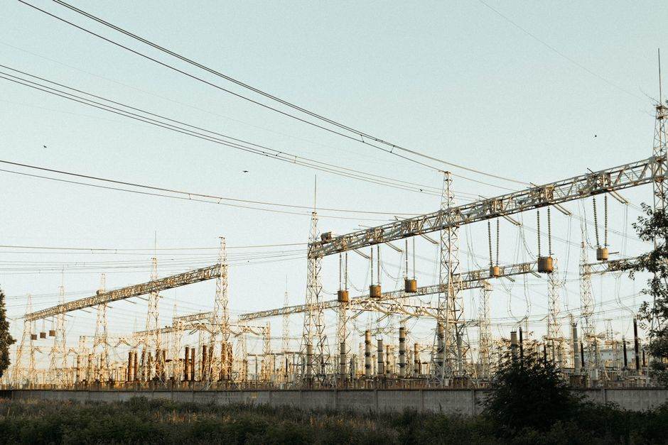 Electric power transmission lines and substations at sunset