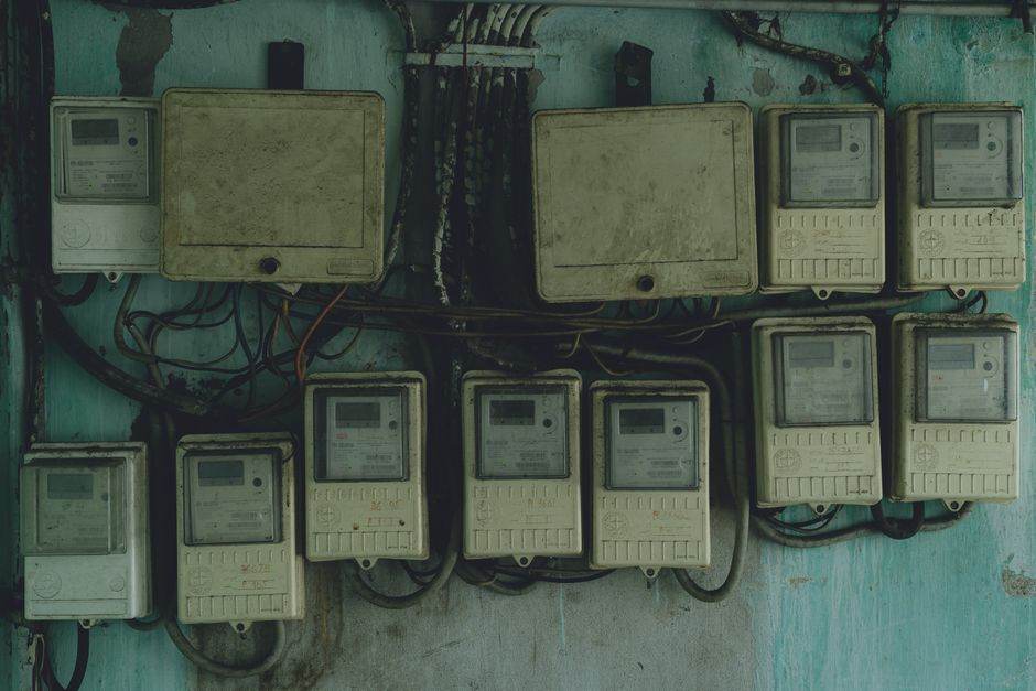 Electricity meter and household energy bill on a table
