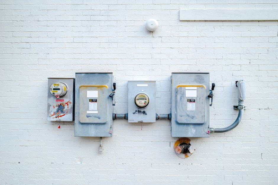 Electricity meter with a modern home interior background
