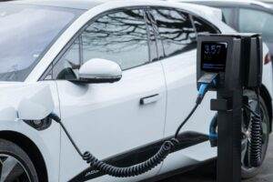 Close-up of an electric vehicle charging at a station, showcasing energy-efficient technology.