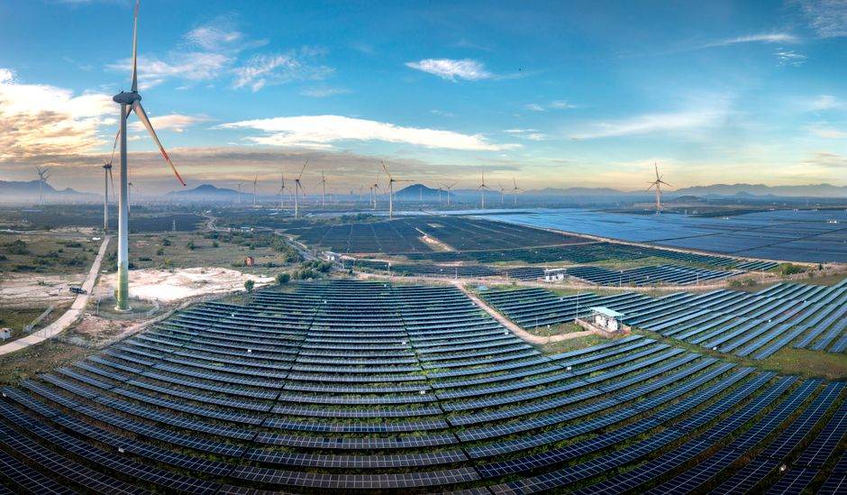 Solar panels and wind turbines powering a modern city