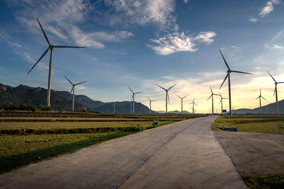 Scenic view of wind turbines in Vietnam countryside during sunset. Clean energy and sustainable landscape.