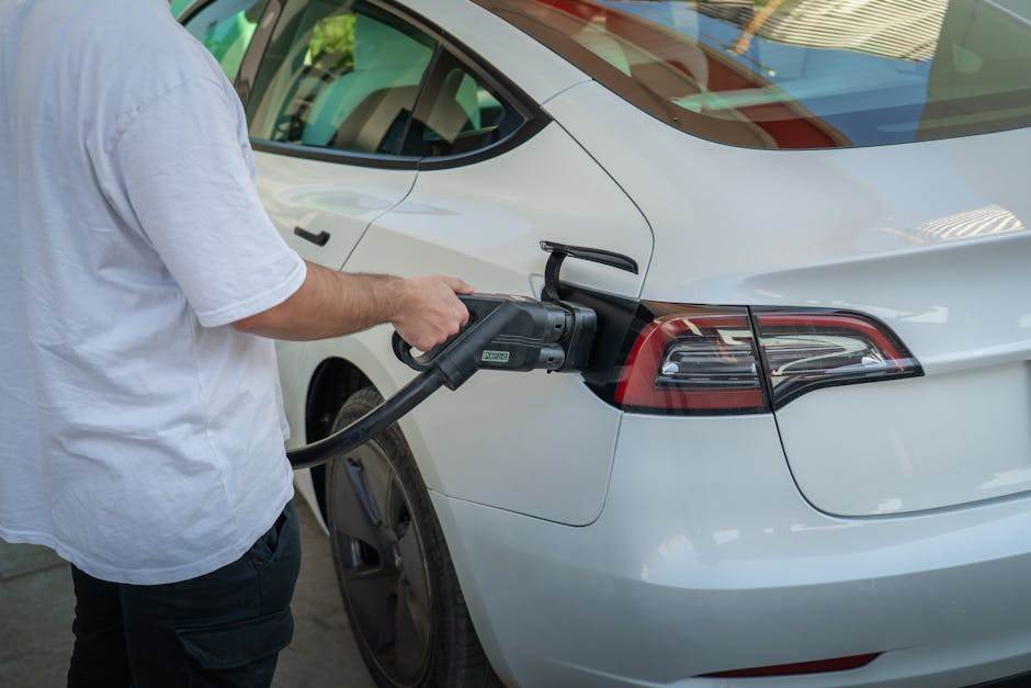 Electric car charging at night in a residential driveway
